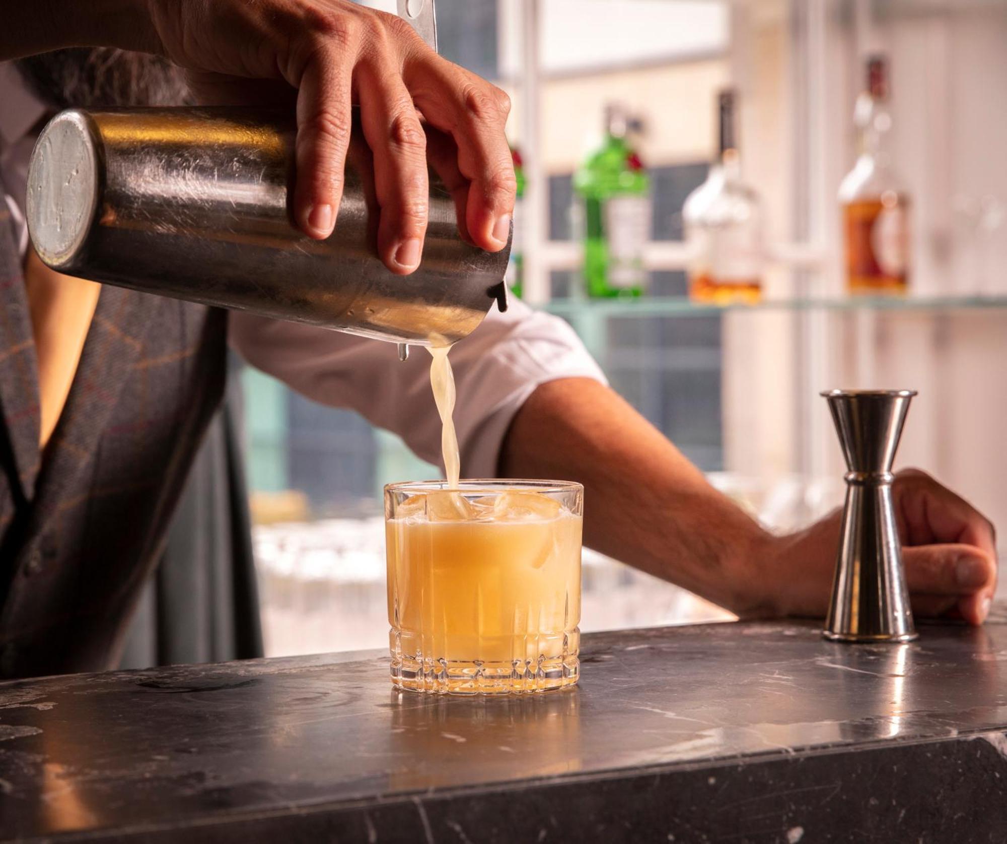 Schloss Roxburghe, Part Of Destination By Hyatt Luaran gambar A bartender straining a cocktail